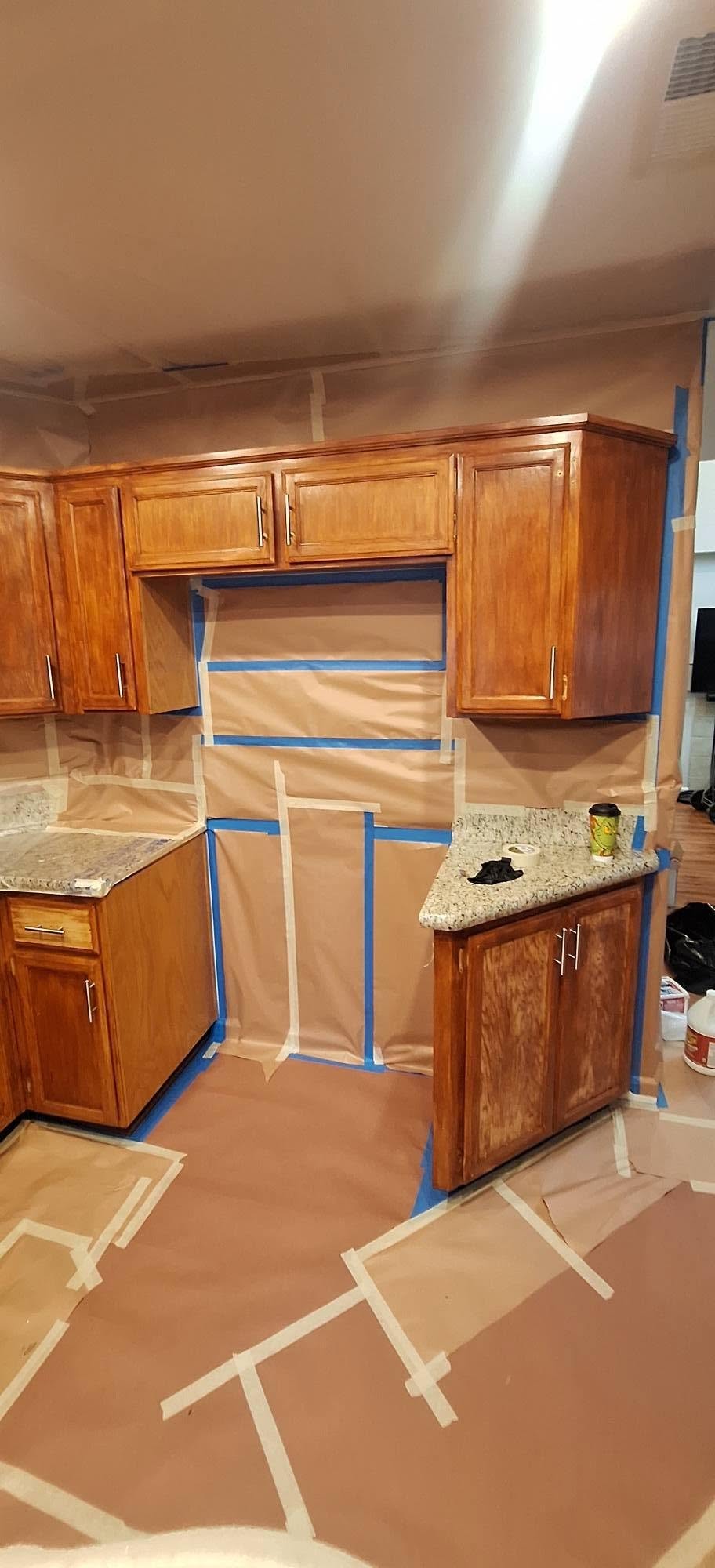 Kitchen fully masked and prepped for cabinet refinishing