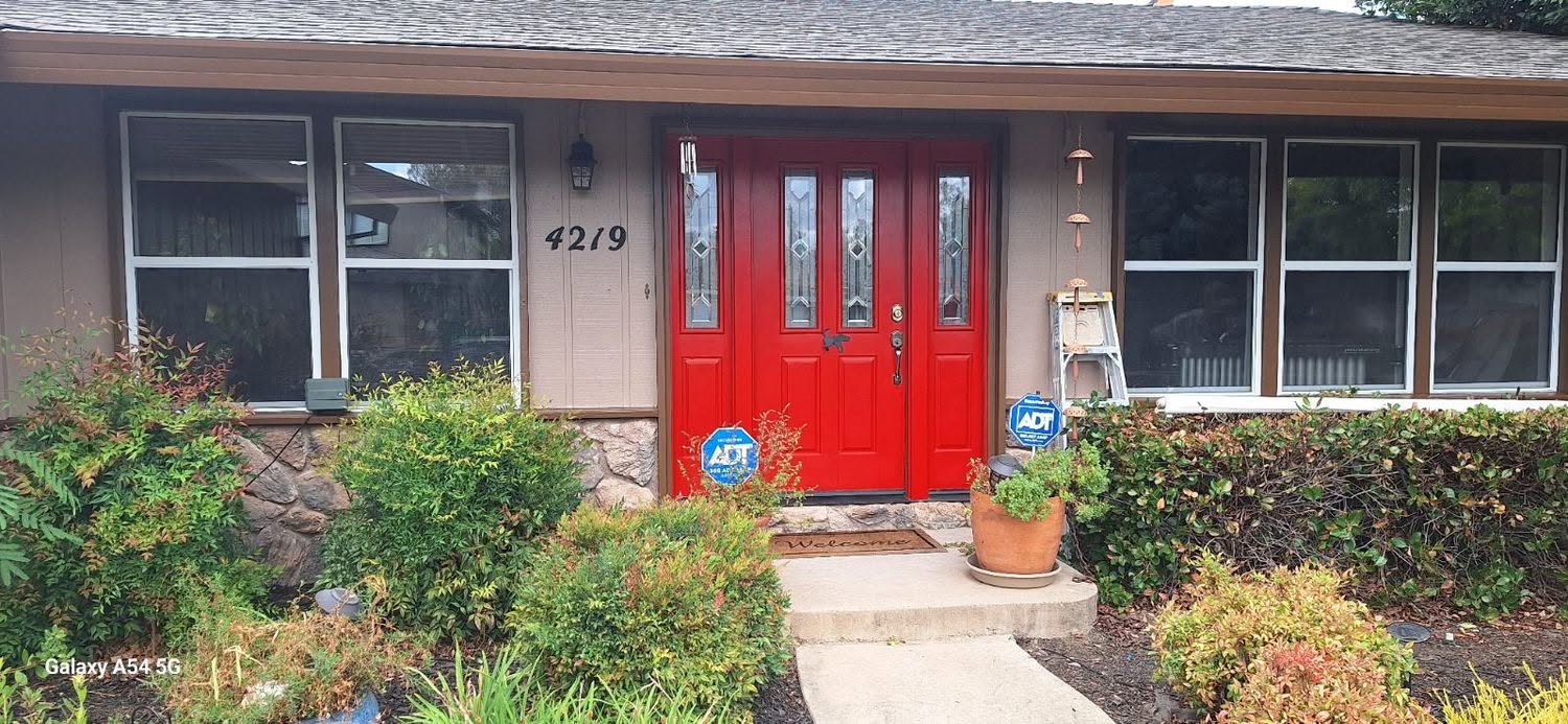 Custom red front door repaint on ranch home