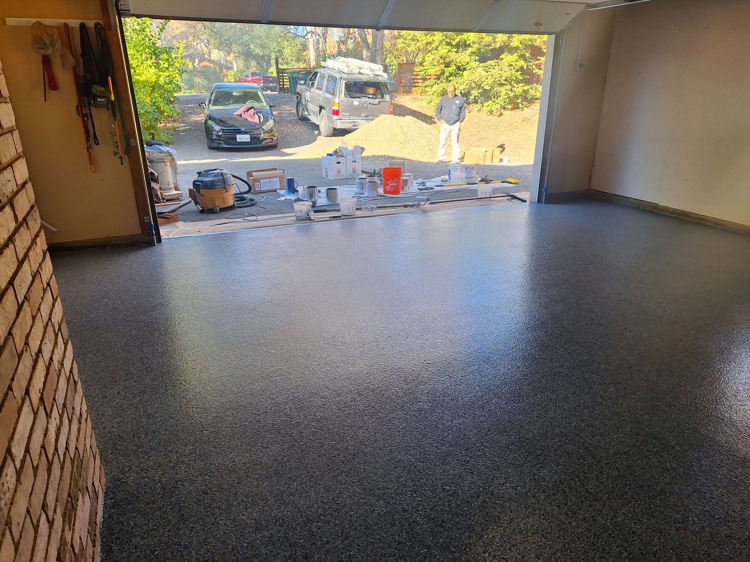 Dark epoxy garage floor with SUV