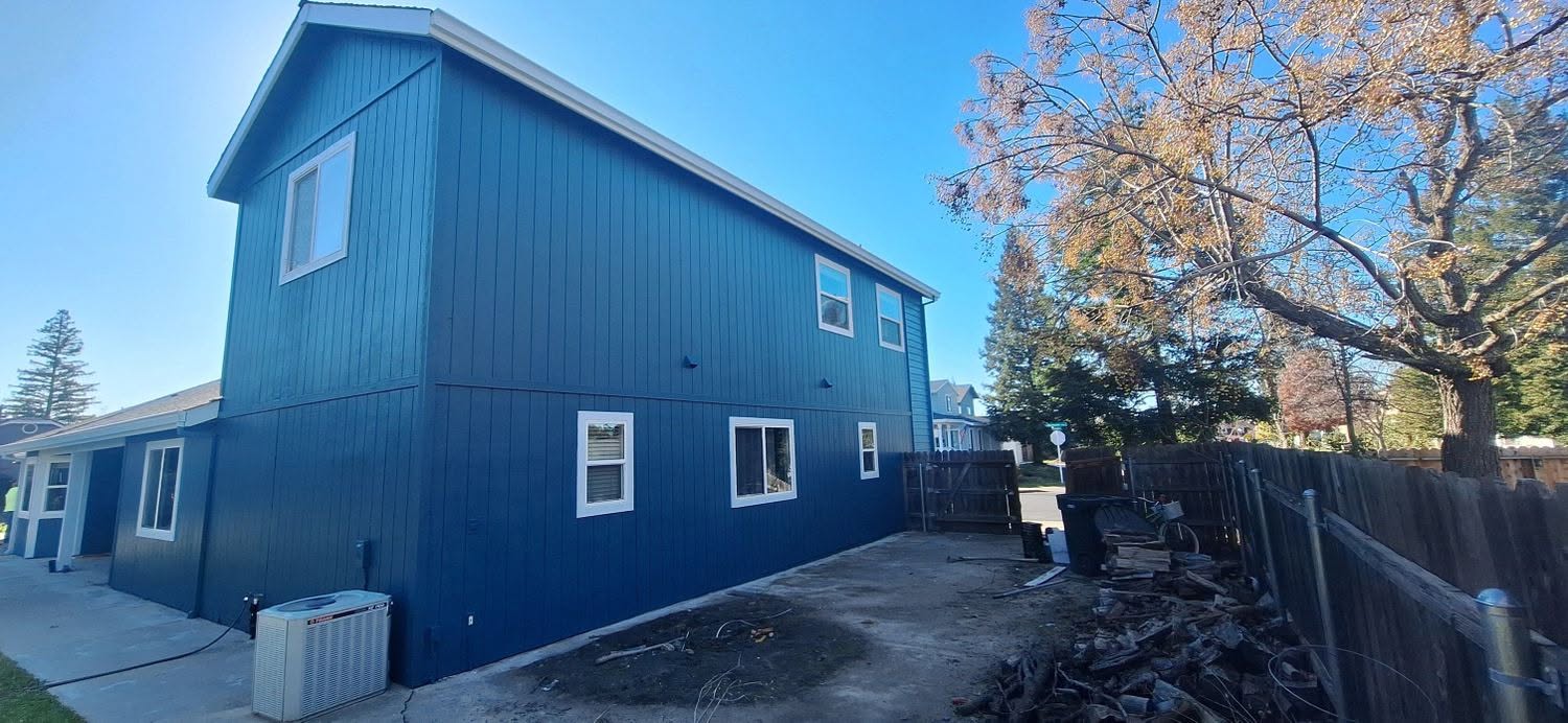 Deep navy siding repaint in Carmichael