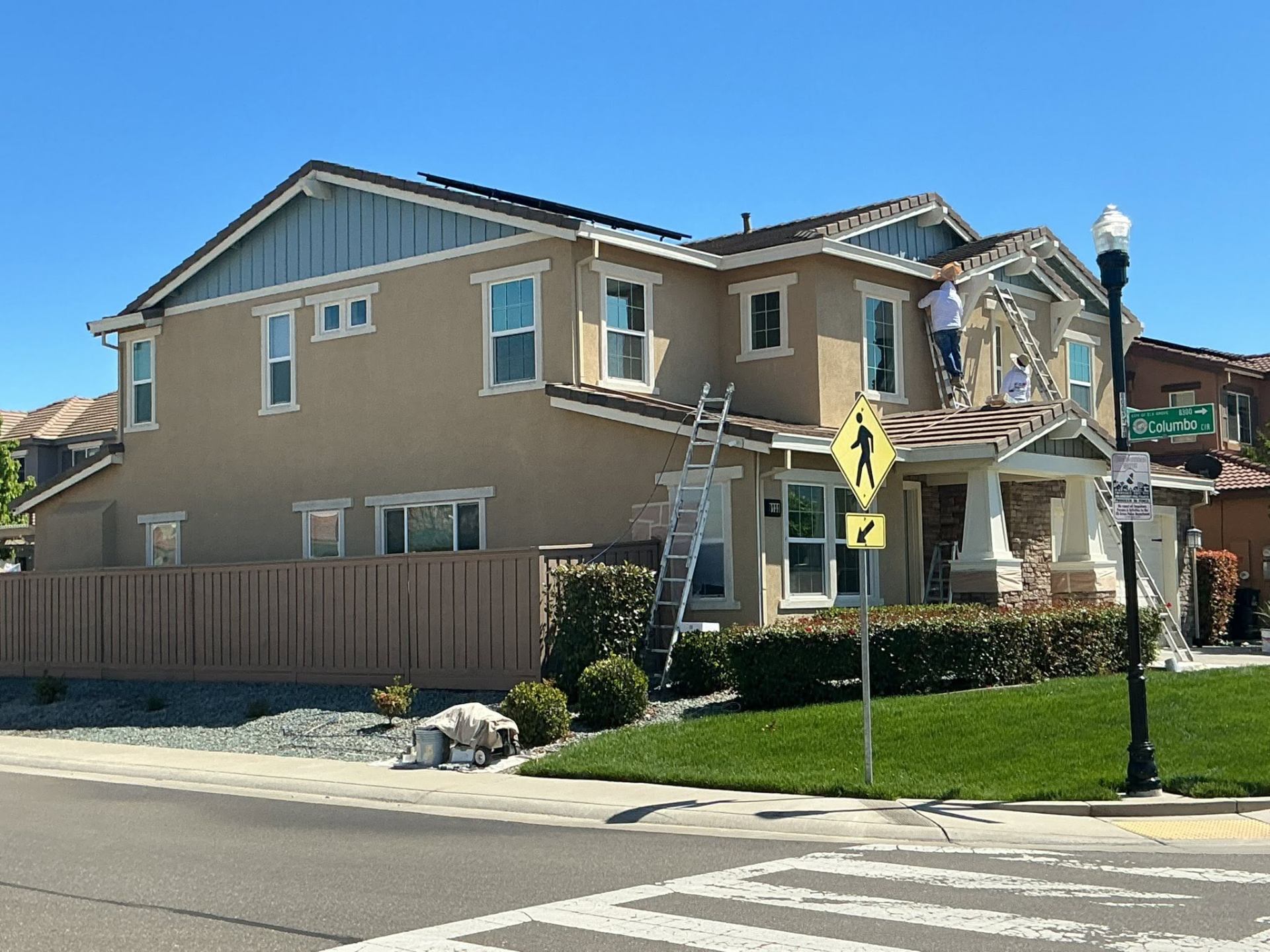 Velasco's crew painting a craftsman two-story